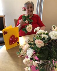 older woman flower arranging